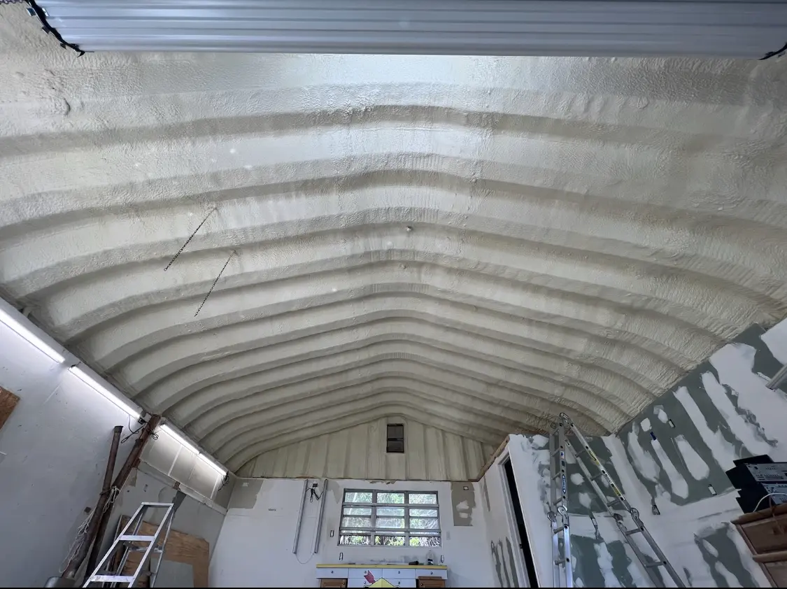 Spray polyurethane foam applied to the underside of a metal roof deck in Landen